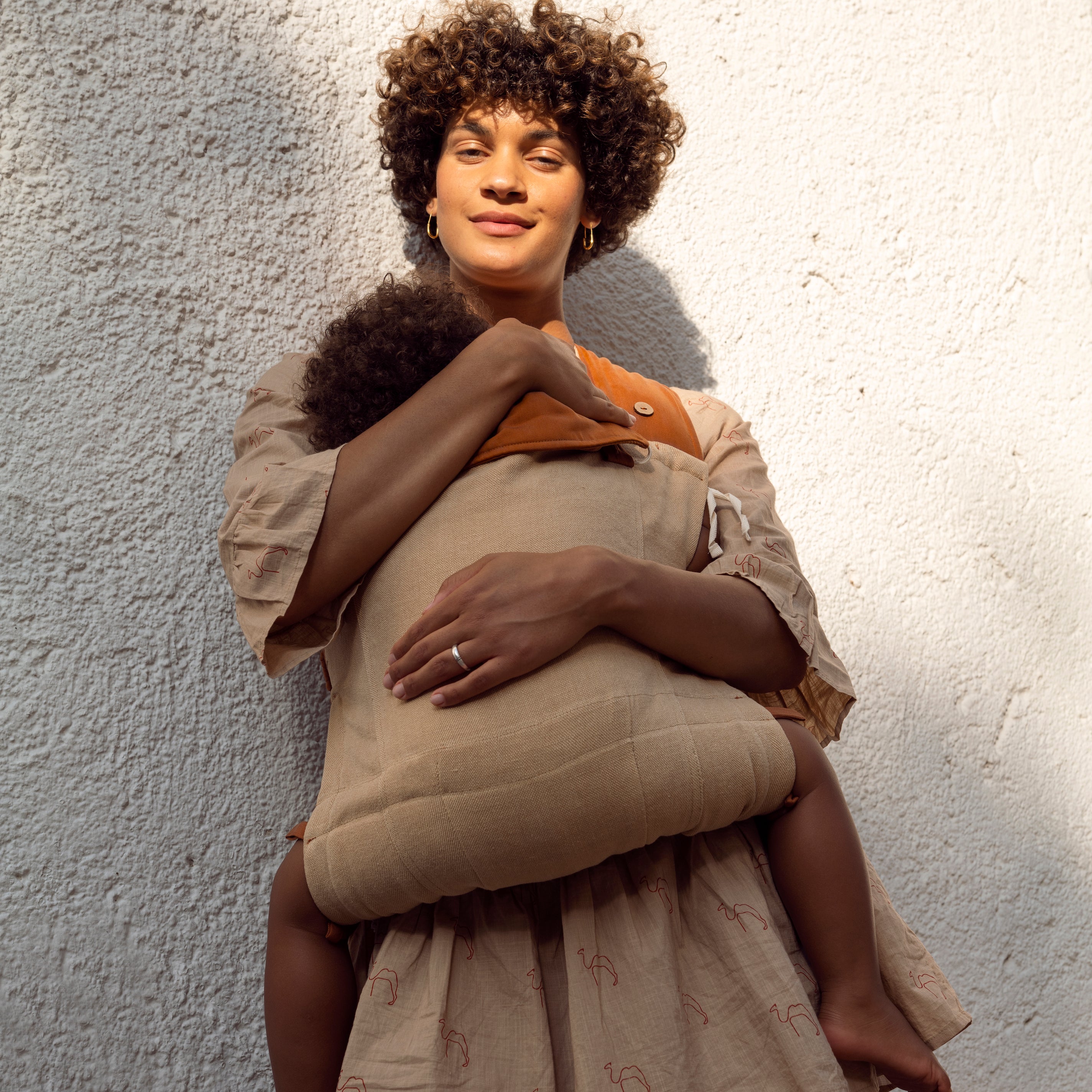 Mutter trägt Baby in Babytrage